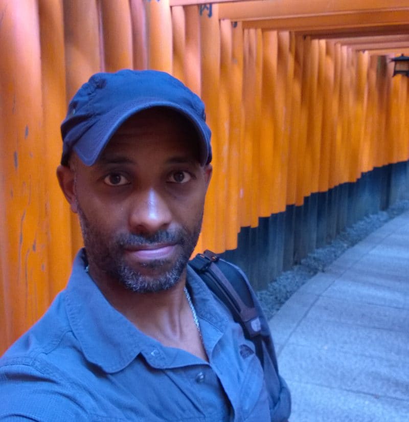 Pedro Jean-Baptiste at a row of torii gates